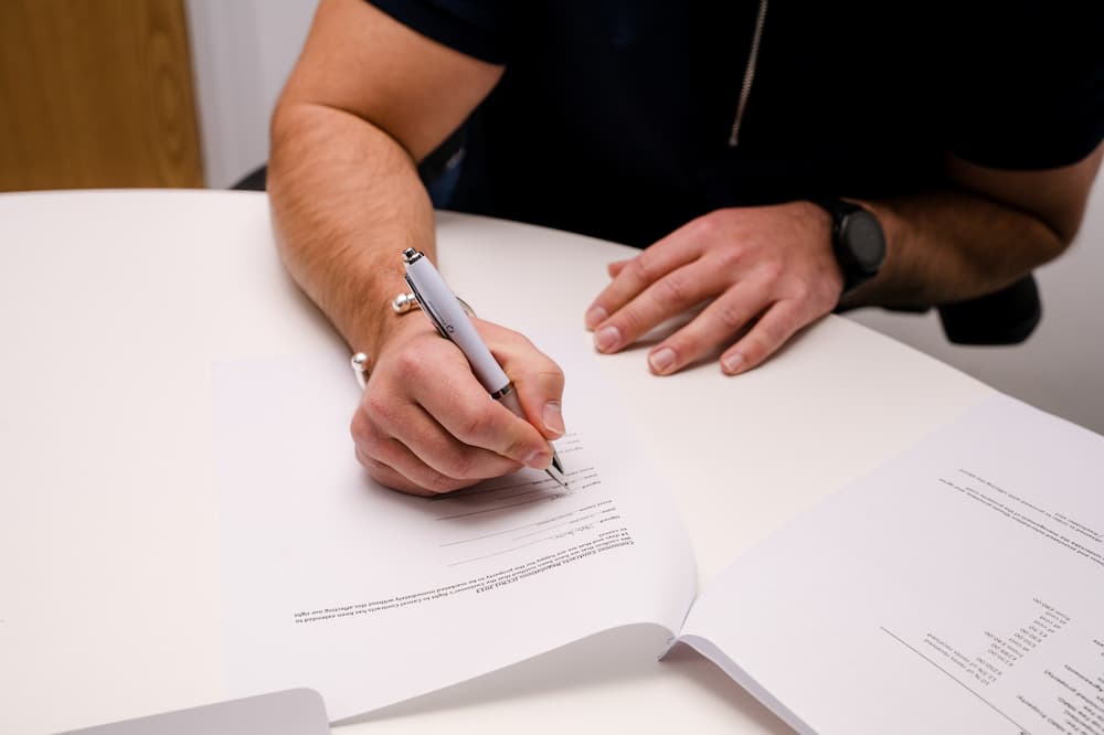 person signing a deposit form